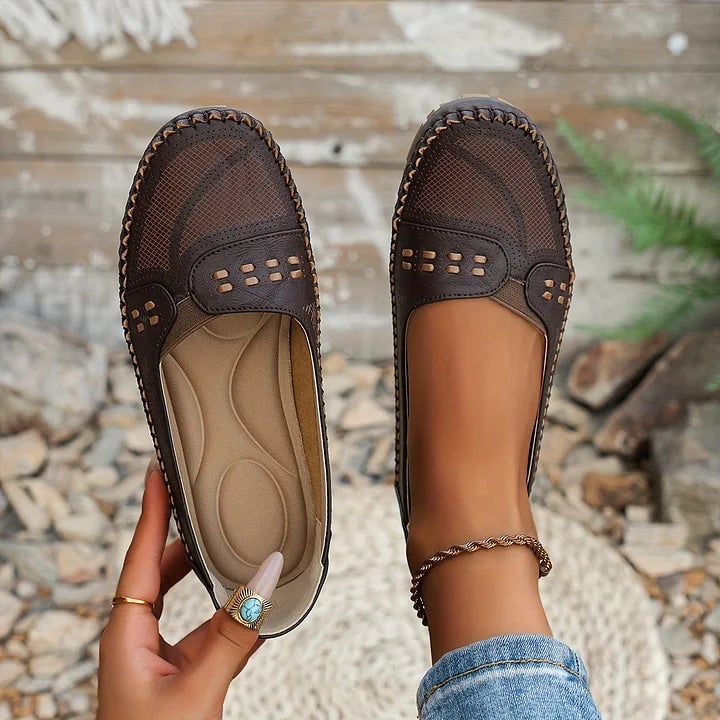 Paulette orthopedic flats in light pink worn by a woman walking outdoors