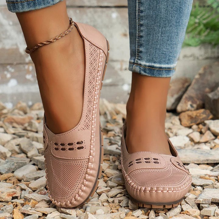 Paulette flat in brown, rear view showing heel construction and non-slip sole edge