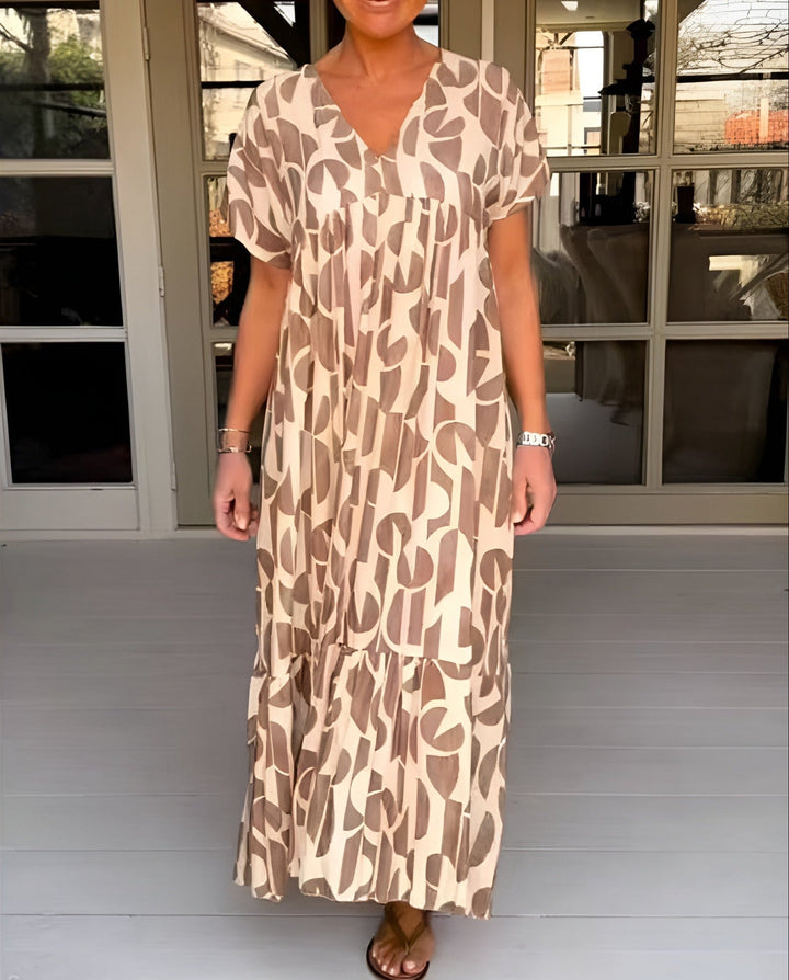 Woman wearing a flowy brown V-neck draped midi dress with an elegant silhouette