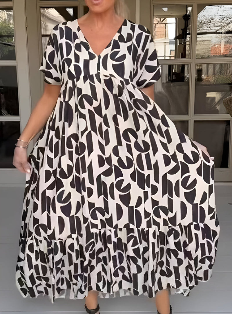 Close-up of the V-neckline and soft drape on a black flowy midi dress