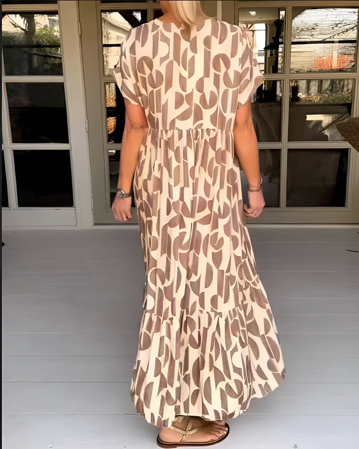 Full-length side view of a woman in a flowy draped midi dress showing fluid movement
