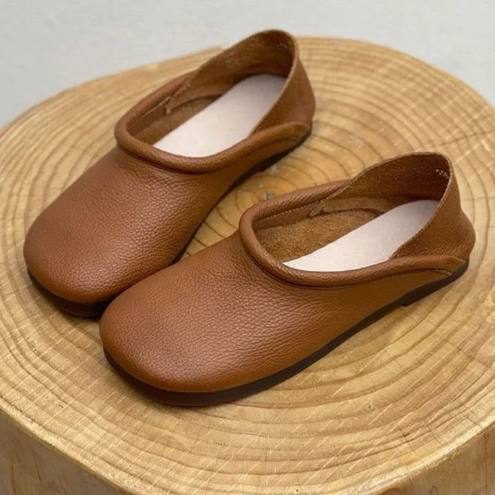 Detail shot of Pearl flat sandal padded footbed and supple vegan leather upper