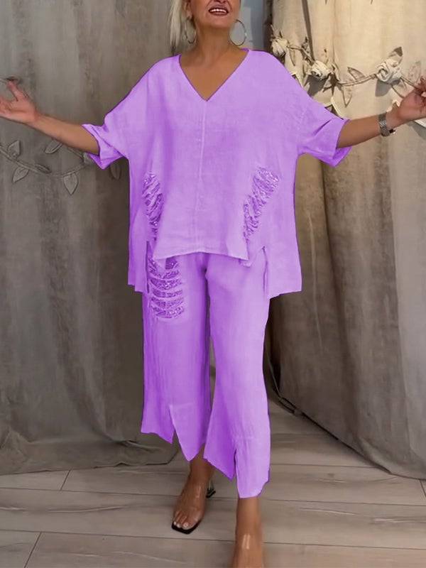 Model wearing the Pearl linen set in black with cropped wide-leg pants and oversized V-neck top
