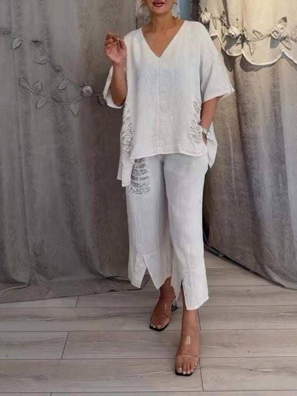 Flat lay of the Pearl linen 2-piece set in light orange displaying the V-neck top and cropped wide-leg pants
