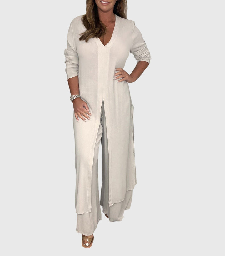 Woman wearing a long open-front duster cardigan and matching wide-leg pants two-piece set in beige