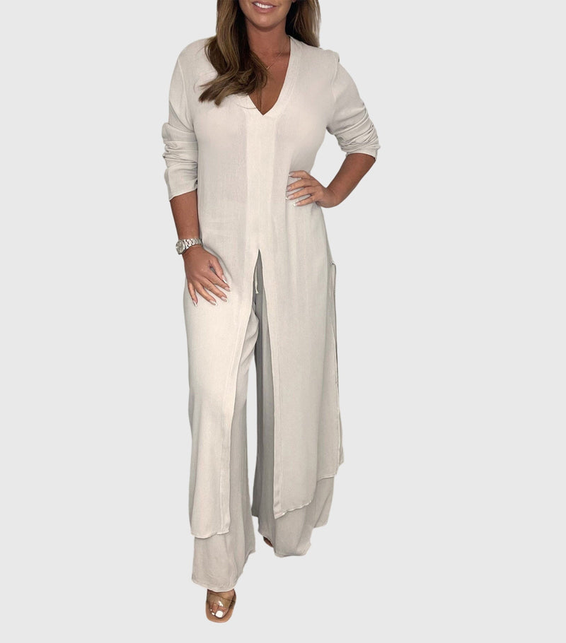 Woman wearing a long open-front duster cardigan and matching wide-leg pants two-piece set in beige