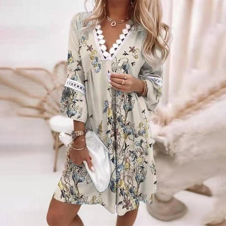 Full-length front view of the Penelope loose fit mini dress in light grey, showing feminine silhouette