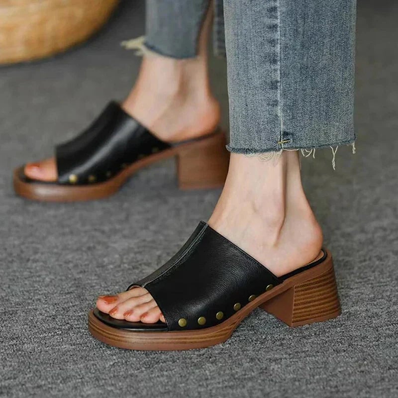 Penelope women's flat sandal in black with minimalist strap design, front view