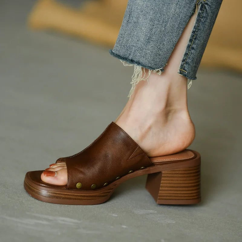 Penelope women's flat sandal in brown, side profile showing sleek silhouette