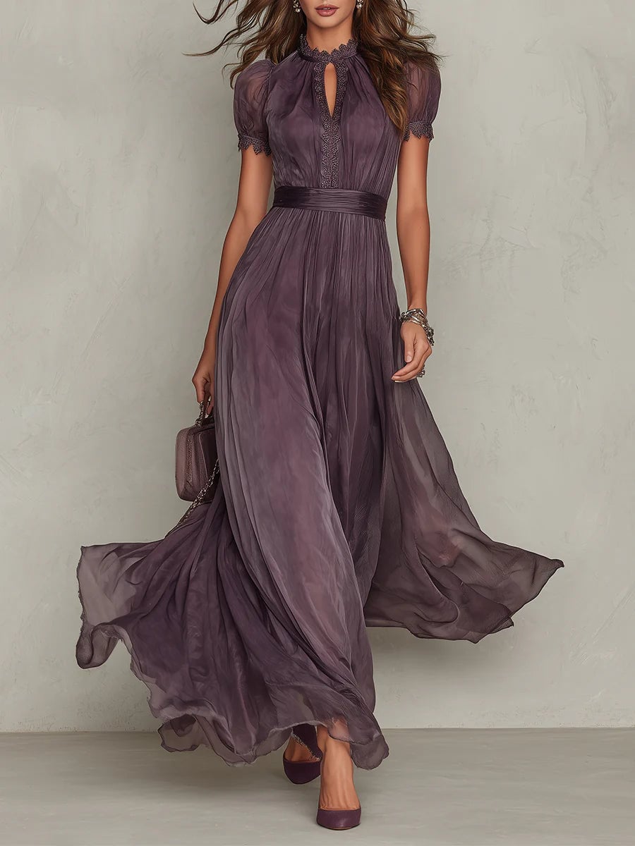 Woman wearing a rich purple short sleeve keyhole maxi dress with flowing skirt, front view