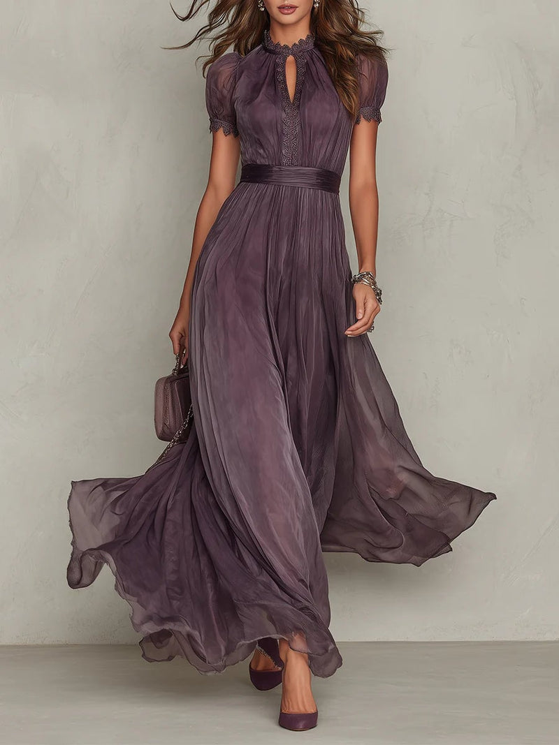 Woman wearing a rich purple short sleeve keyhole maxi dress with flowing skirt, front view