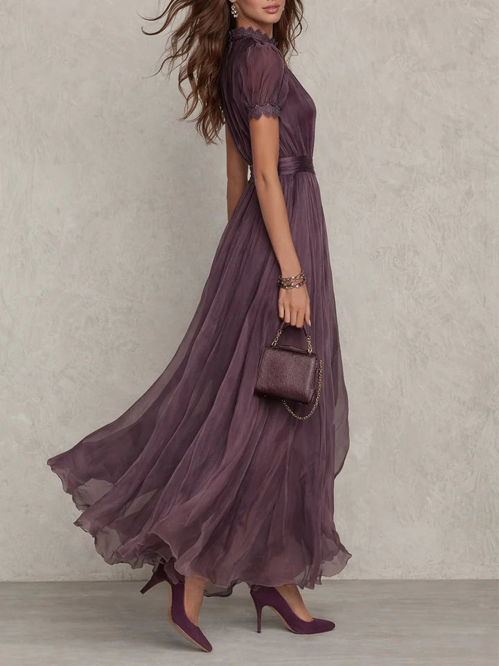 Close-up of the keyhole neckline and short puff sleeves on a purple maxi dress