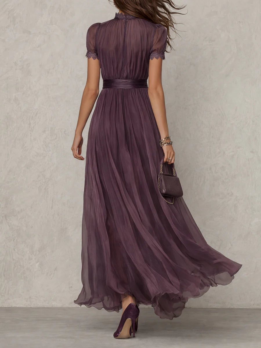 Side view of a woman in a purple keyhole maxi dress showing the fluid maxi length