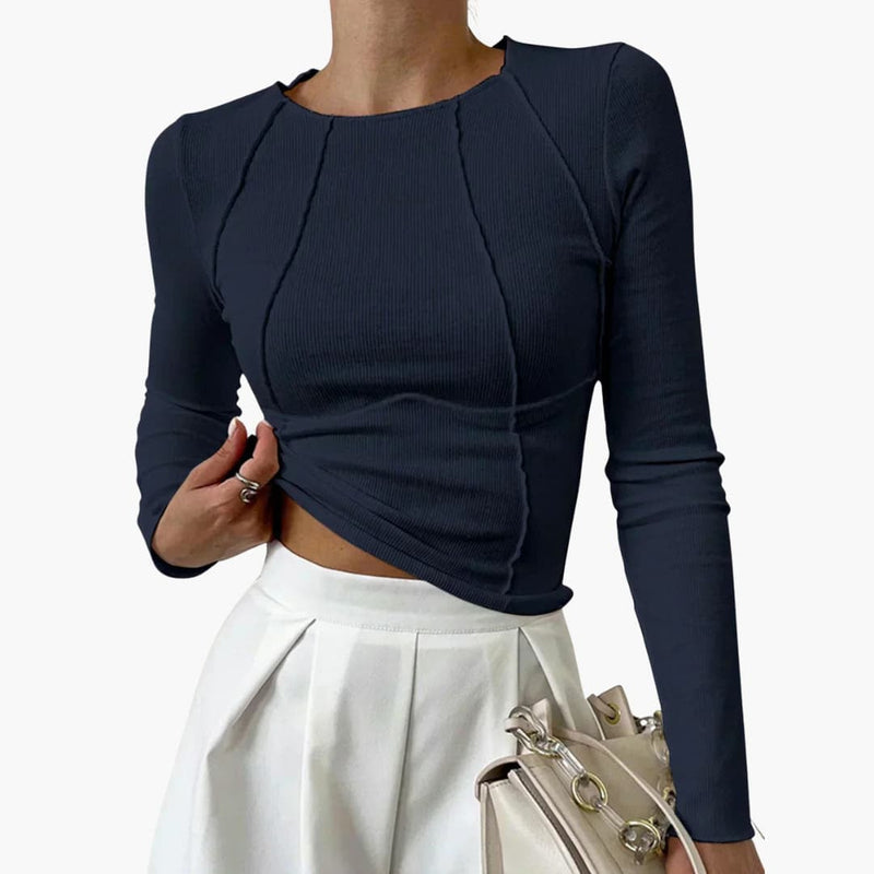 Model wearing the sculpted seam long sleeve top tucked into high-waist trousers for a polished everyday look