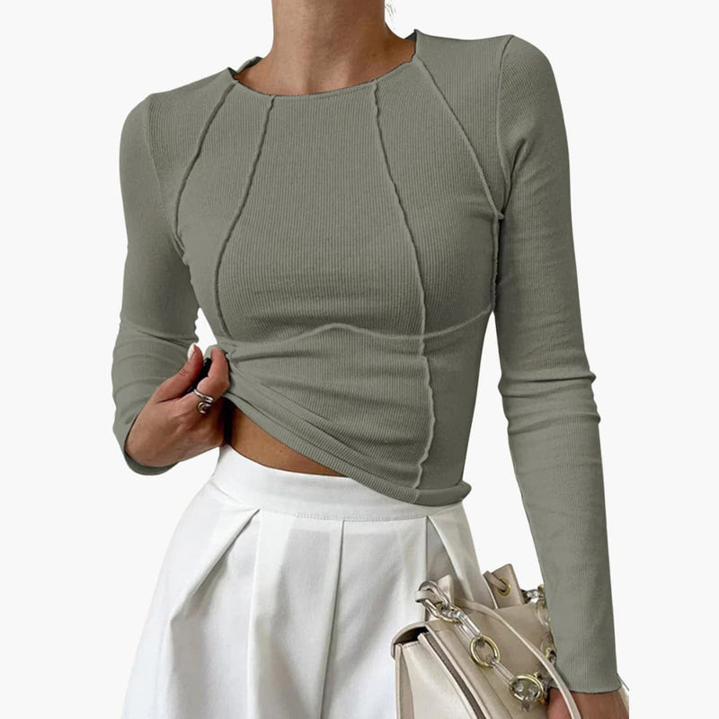 Side profile of the sculpted seam long sleeve top showing full torso coverage and fitted silhouette