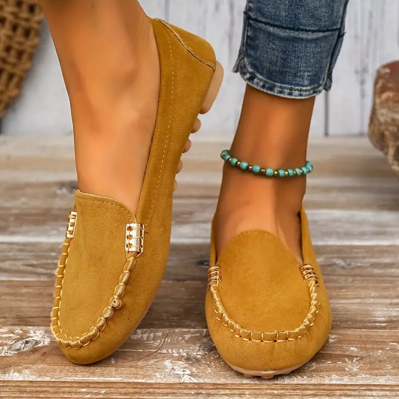 Penny slip-on loafer in mustard yellow with contrast topstitching, shown at a three-quarter angle