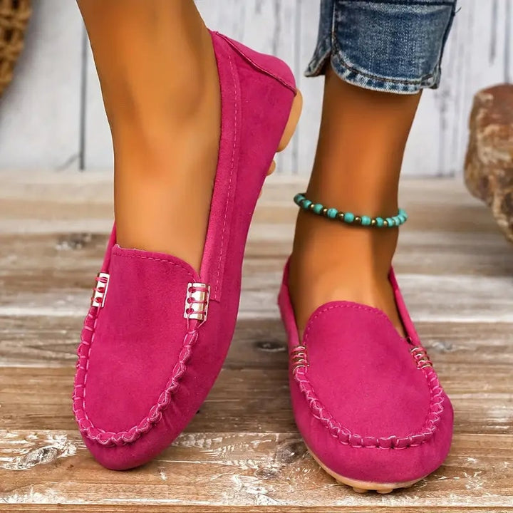 Close-up of Penny loafer in hot pink highlighting the gold-tone hardware bar and artisan stitching detail