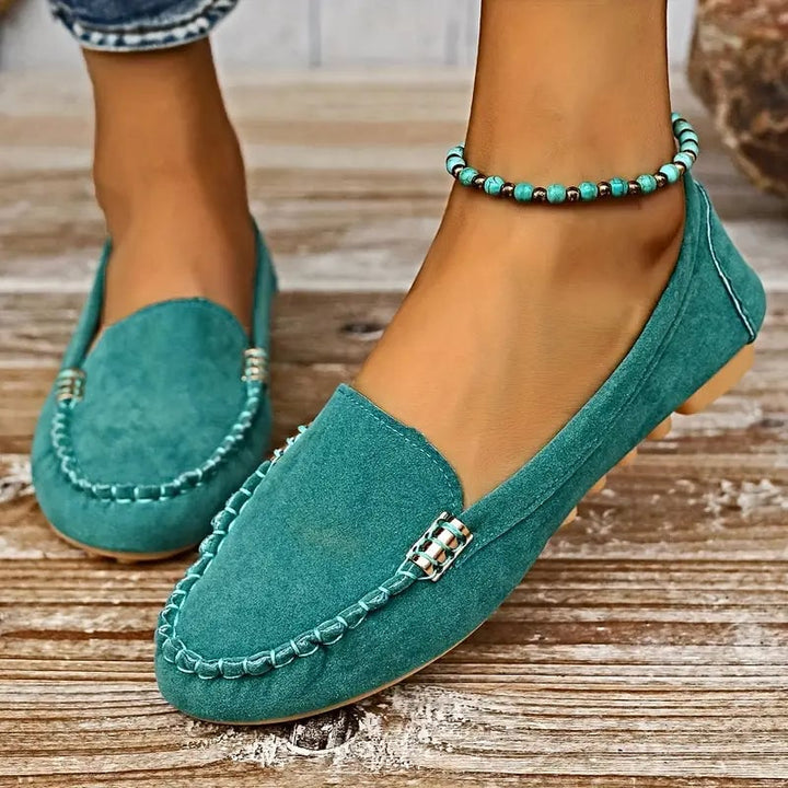 Penny women's flat loafer in turquoise displayed on a clean background, showcasing the rounded moc-toe silhouette