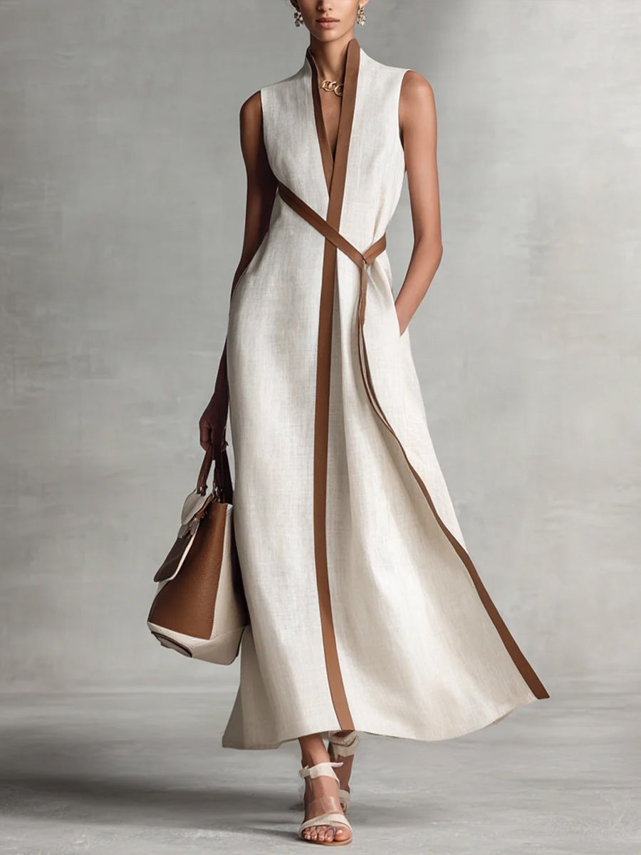 Close-up of the wrap bodice and V-neckline detail on a sleeveless maxi dress in white