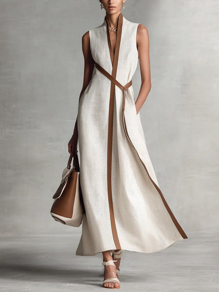 Close-up of the wrap bodice and V-neckline detail on a sleeveless maxi dress in white