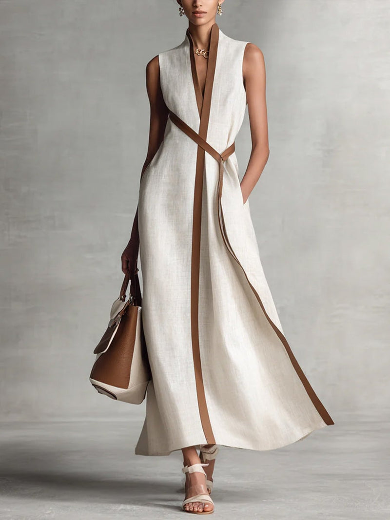 Close-up of the wrap bodice and V-neckline detail on a sleeveless maxi dress in white