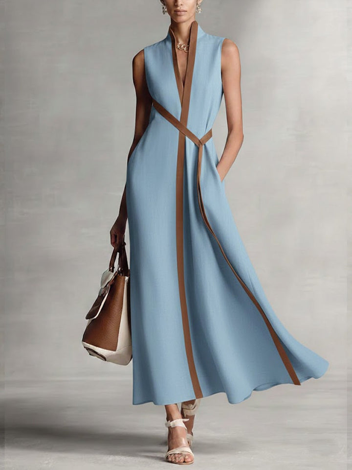 Woman in a navy blue sleeveless wrap maxi dress posing outdoors, showcasing the maxi length