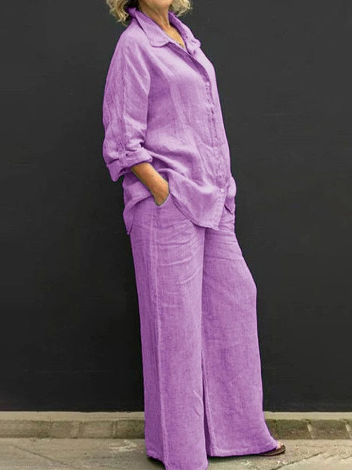 Woman wearing the Petra linen two-piece set in purple, featuring an oversized long sleeve button-down shirt and wide-leg pants
