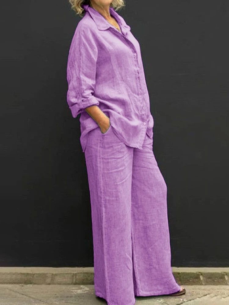 Woman wearing the Petra linen two-piece set in purple, featuring an oversized long sleeve button-down shirt and wide-leg pants