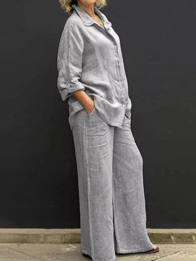 Side view of the Petra flowing wide-leg linen pants showing the clean, elongating silhouette in gray