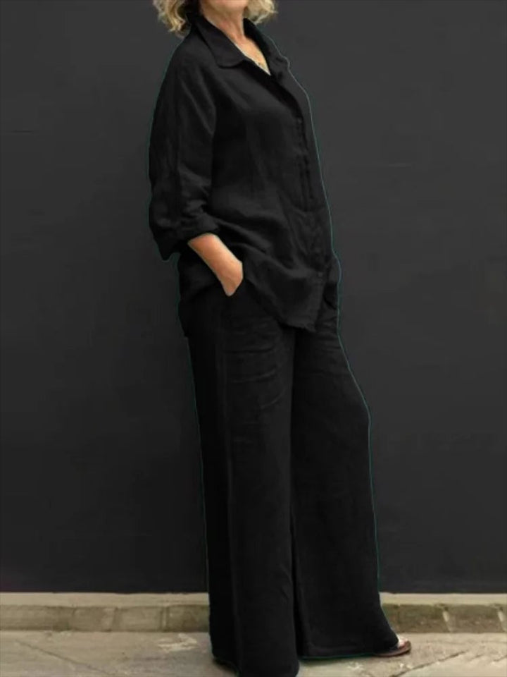 Petra linen set in black worn with the shirt open over a white tee, showing mix-and-match styling