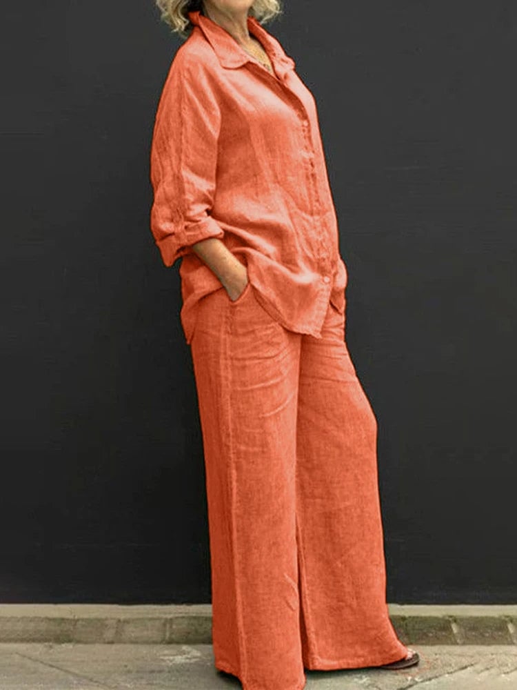 Flat lay of the Petra linen shirt and wide-leg pants set in orange showing both pieces side by side