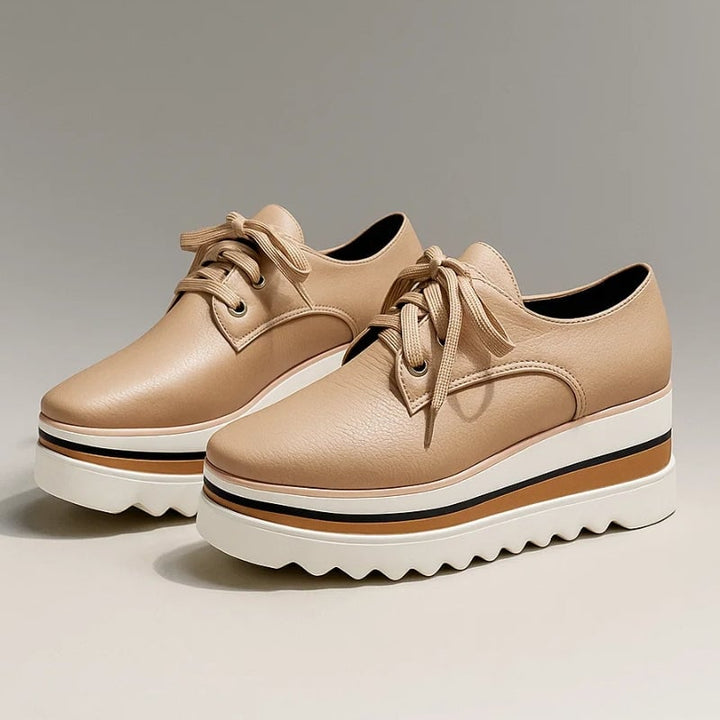Petra platform Oxford lace-up wedge sneaker in beige with striped cream, tan, and black sole, front three-quarter view