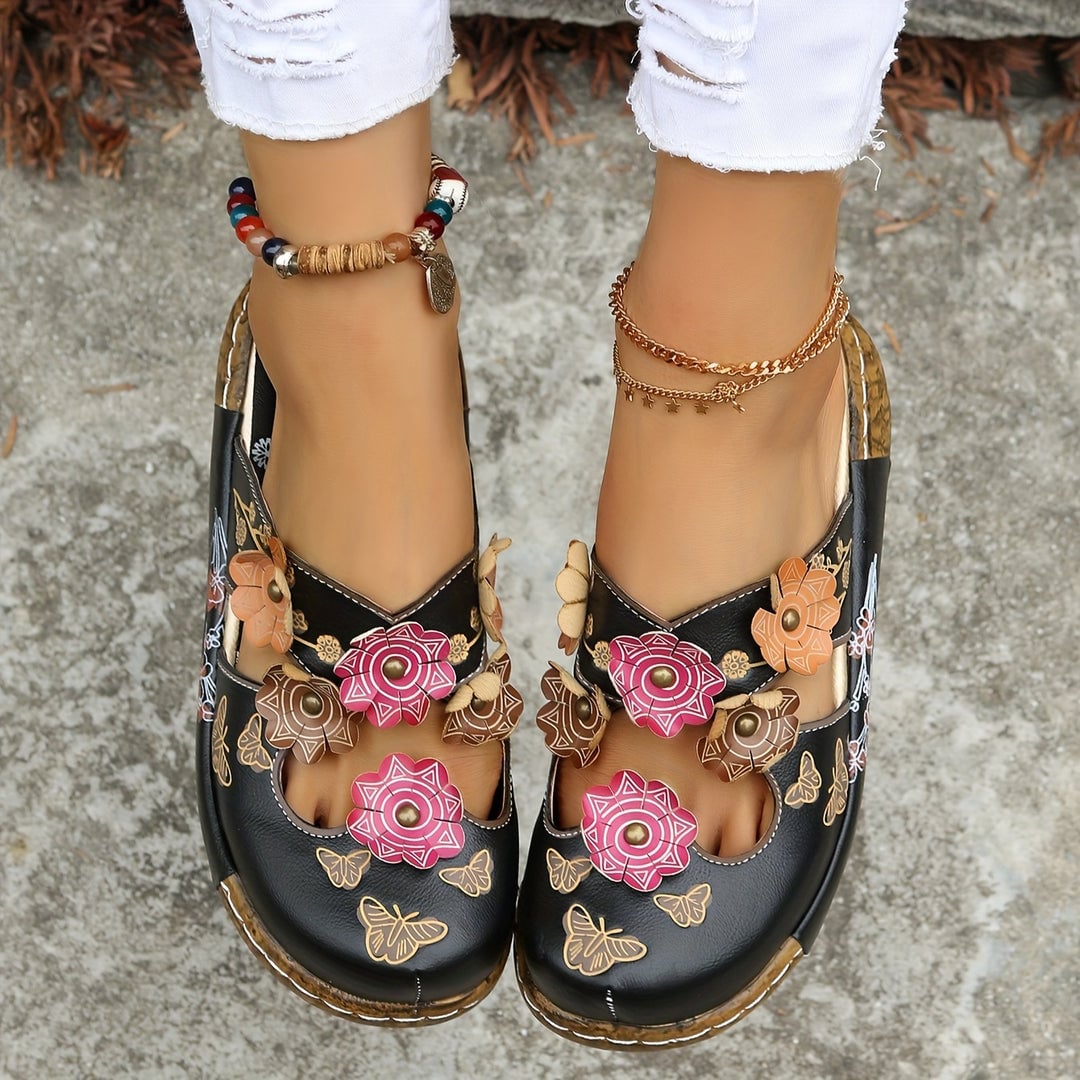 Close-up of the Phoebe wedge sandal's textured non-slip sole and heel detail in black