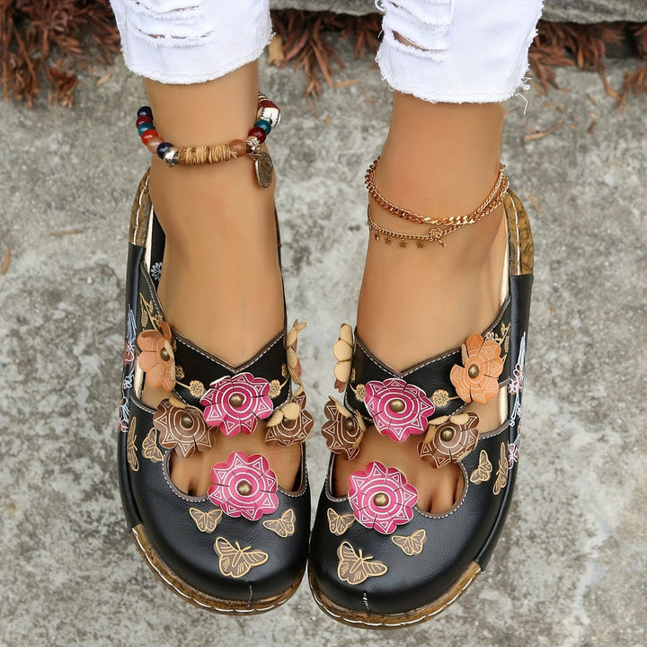 Close-up of the Phoebe wedge sandal's textured non-slip sole and heel detail in black