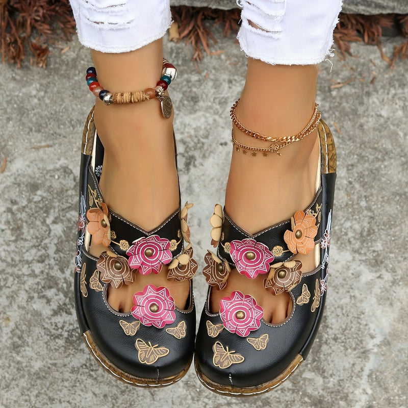 Close-up of the Phoebe wedge sandal's textured non-slip sole and heel detail in black