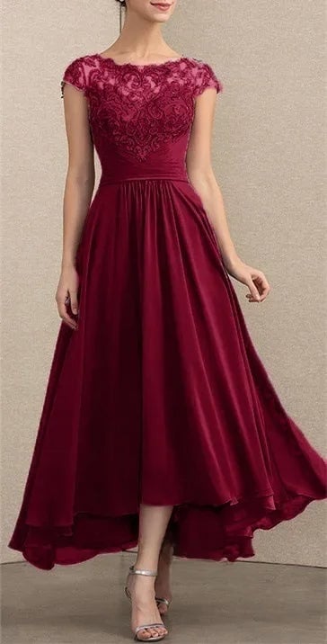 Model wearing an elegant lace chiffon maxi dress in burgundy with delicate lace neckline and flowing skirt