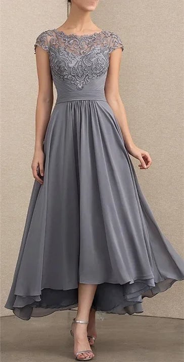 Close-up of lace sleeve and chiffon fabric detail on an elegant maxi dress in grey
