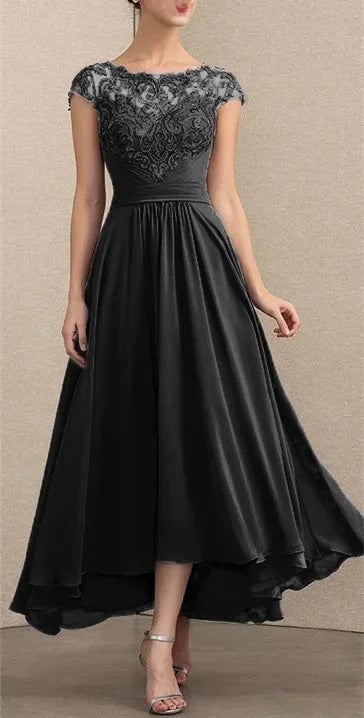 Full-length view of a woman in a black lace chiffon maxi dress showing the elongated silhouette