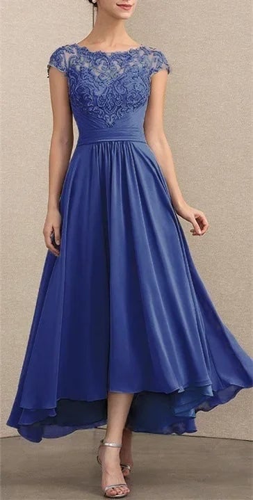 Model posing in a blue lace chiffon maxi dress highlighting the draped chiffon and lace accents