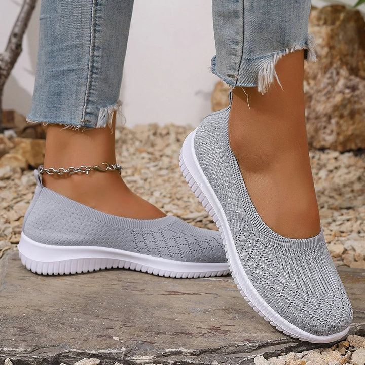 Women's breathable slip-on shoes in gray with a cushioned anti-slip sole, shown from the side