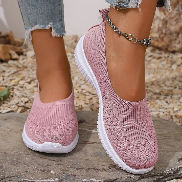 Removable cushioned footbed of women's slip-on shoes shown lifted out of the shoe