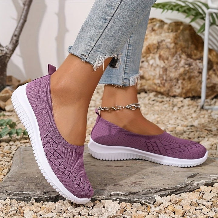 Bottom view of women's slip-on shoes showing the textured anti-slip rubber sole