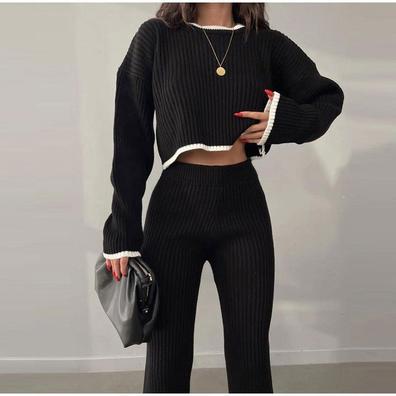 Model posing in orange knitted cropped sweater and matching high-waisted pants