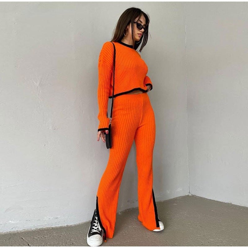 Full-length view of the Piper two-piece knit set in pink styled with heeled boots
