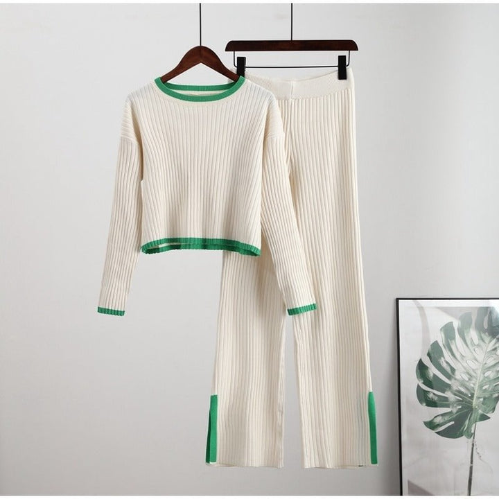 Lifestyle shot of model in green knitted two-piece set carrying a neutral tote bag