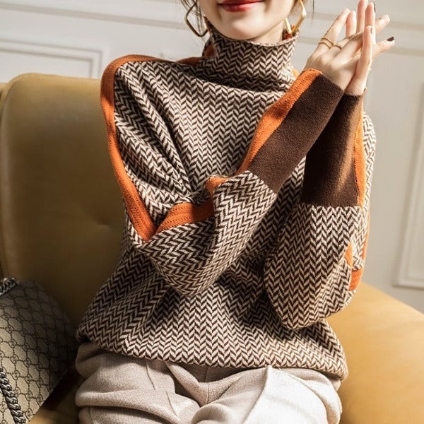 Model wearing the Florimay herringbone luxe turtleneck in orange styled with trousers