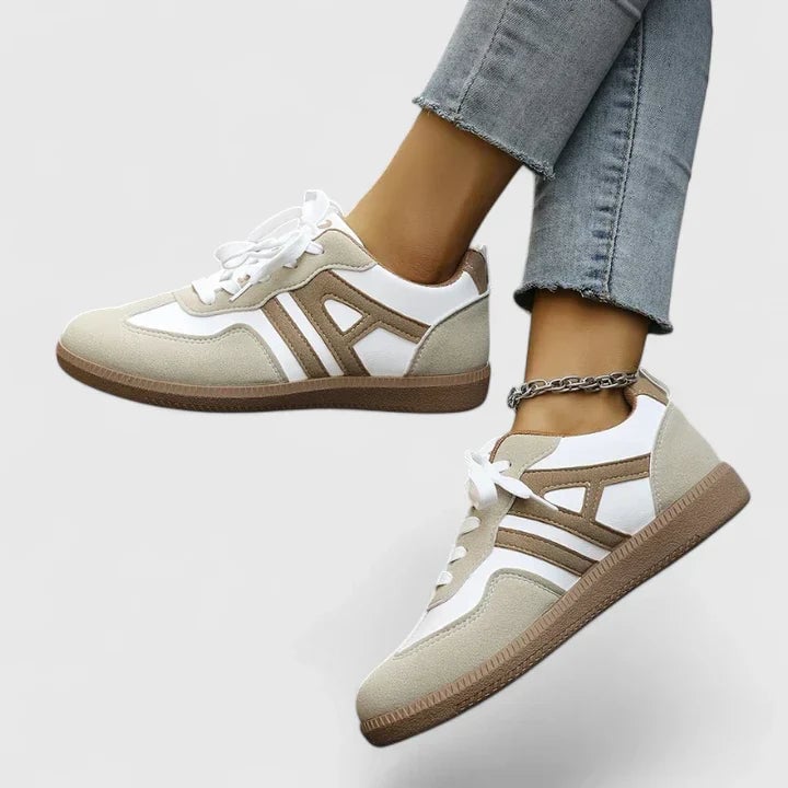 Close-up of Piper retro sneaker showing beige suede-look panels, wide flat white laces, and natural tan gum outsole