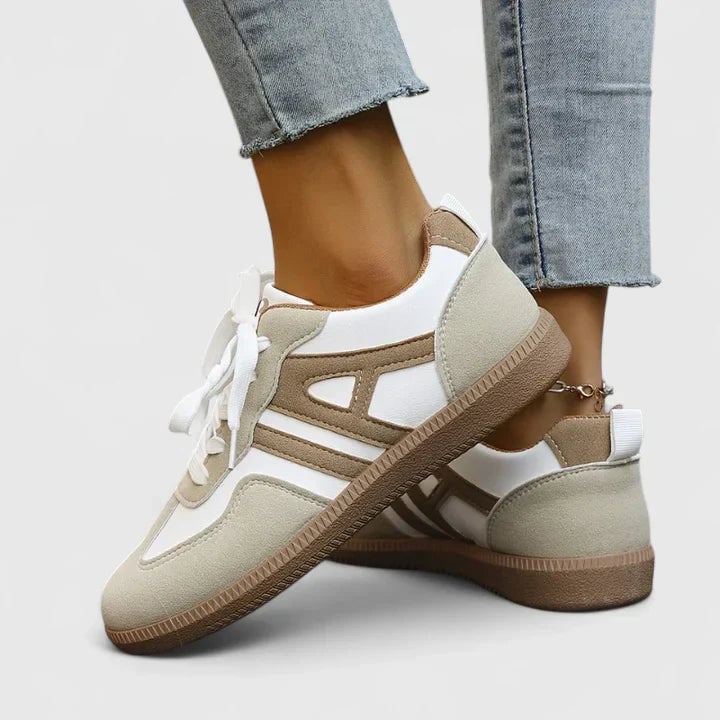 Side profile of Piper retro low top sneaker in beige and white highlighting tonal stripe detail and sleek low silhouette