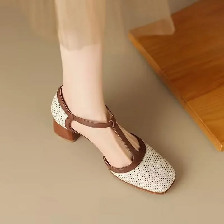 Close-up of perforated upper and contrast T-strap buckle on Piper block heel pump