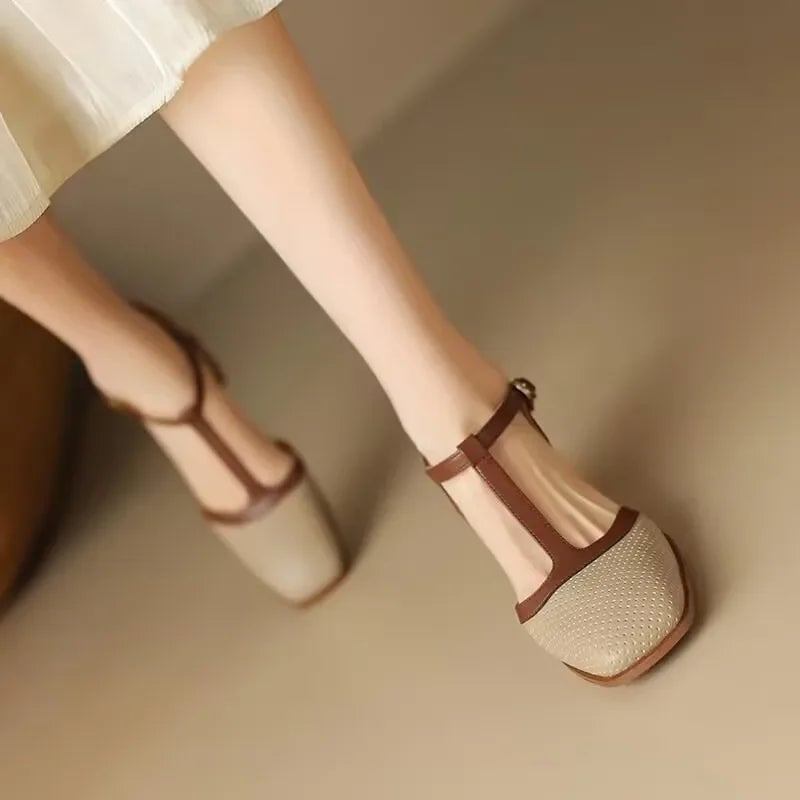 Model wearing Piper beige T-strap block heel pumps styled with a flowy midi dress